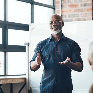 man speaking in front of a group