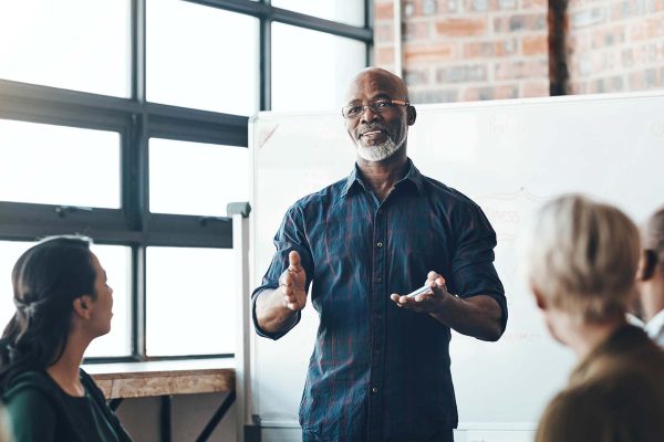 man speaking in front of a group